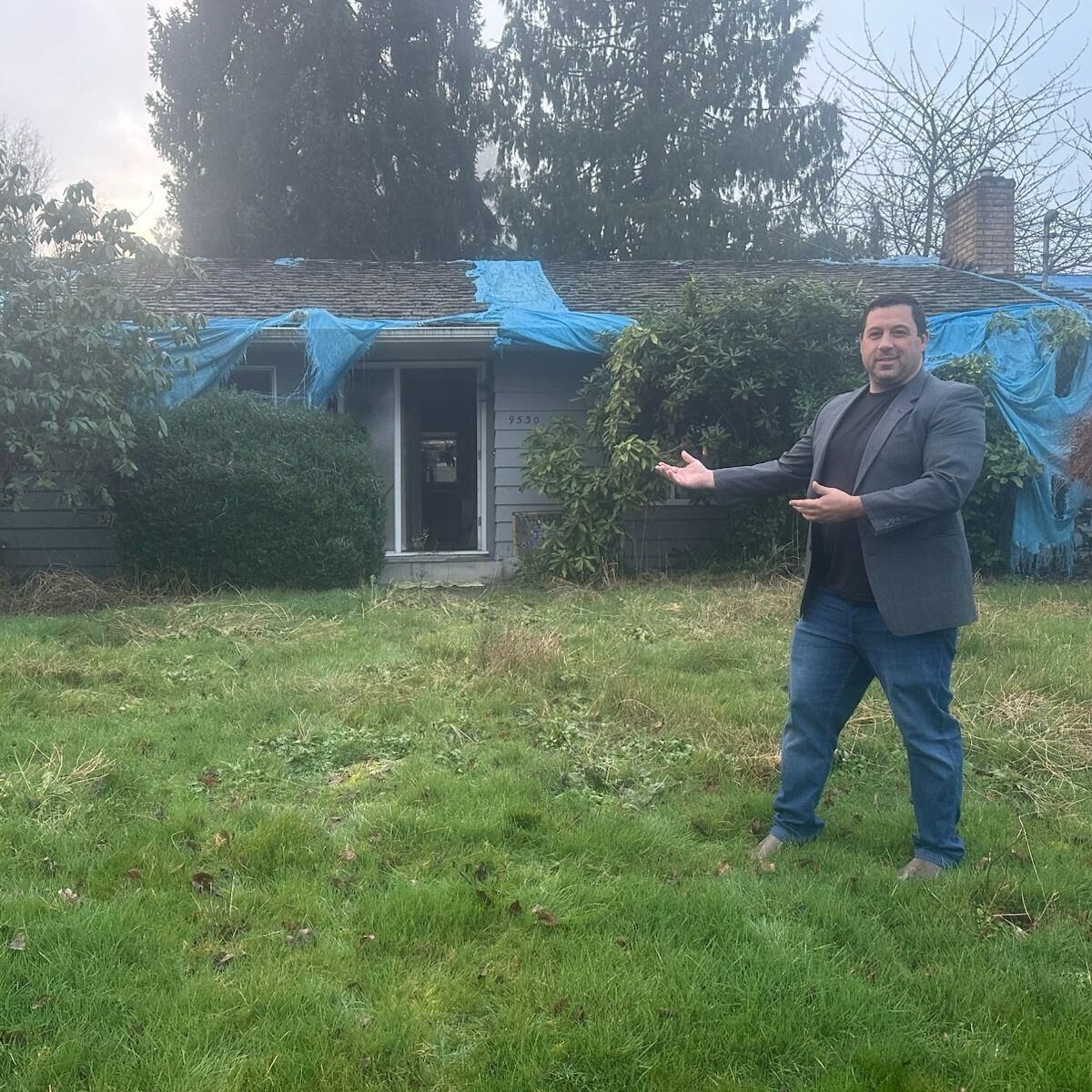 Corey Ihler in front of the distressed Silver Lake property on acquisition day, tarped roof visible